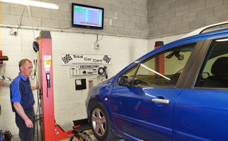 MOT Tester lifting car for inpsection during Daventry MOT